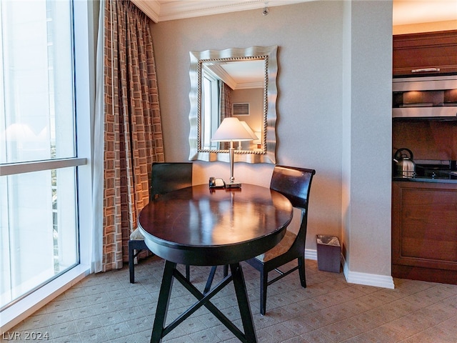 dining space with crown molding and a wealth of natural light