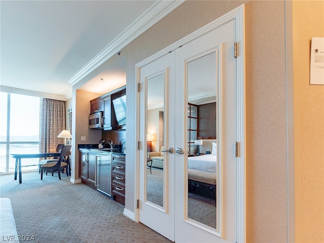 interior space with light carpet, crown molding, and french doors