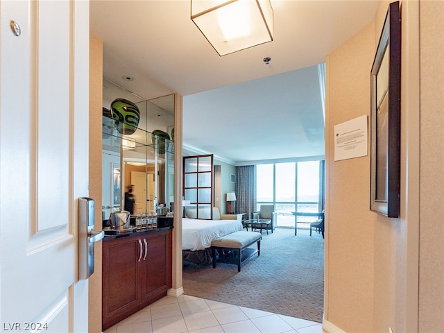 bathroom featuring floor to ceiling windows, tile flooring, and vanity