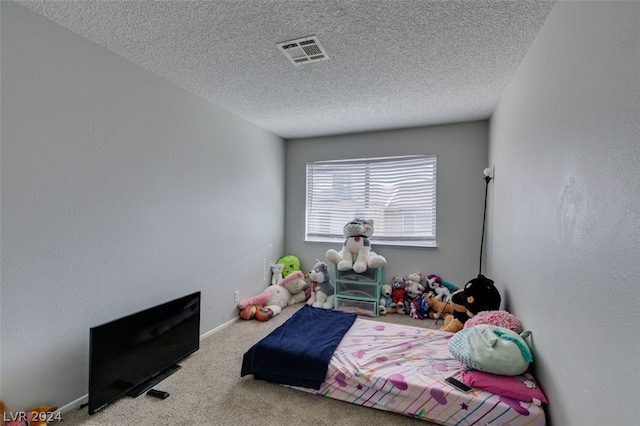 carpeted bedroom with a textured ceiling