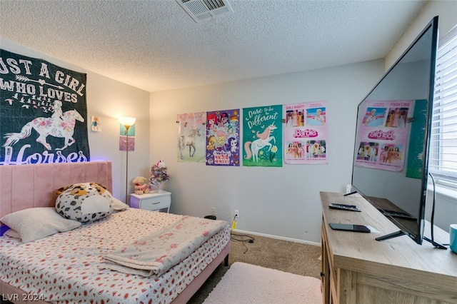 bedroom with a textured ceiling and light carpet