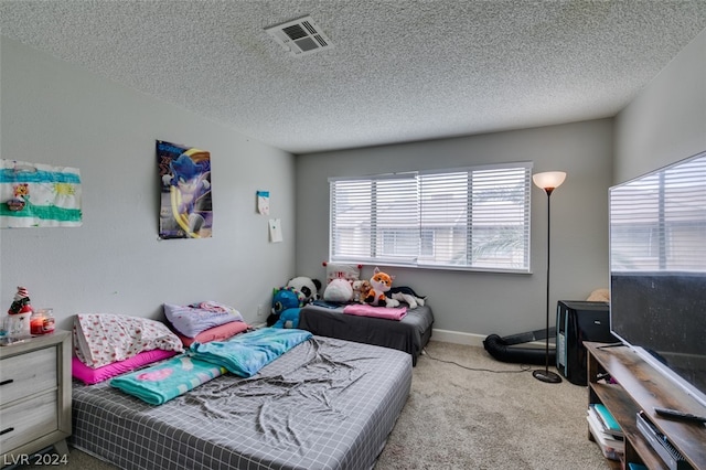 carpeted bedroom featuring a textured ceiling