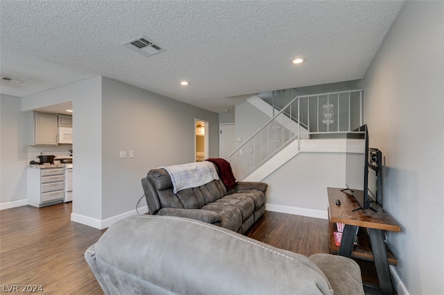 living room featuring a textured ceiling and hardwood / wood-style floors