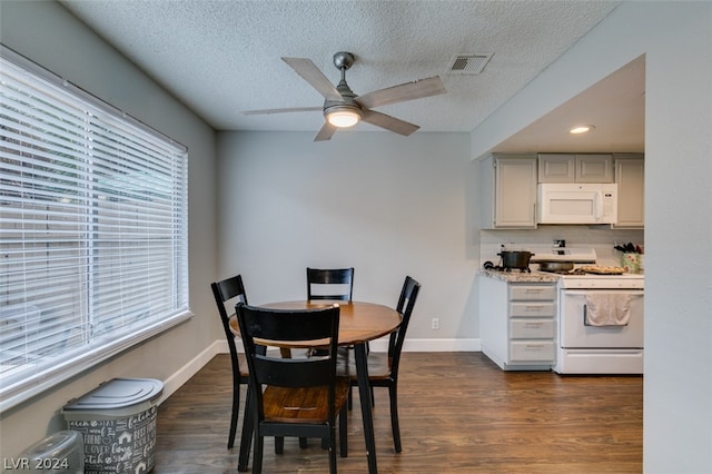 dining area with a textured ceiling, ceiling fan, dark hardwood / wood-style floors, and plenty of natural light