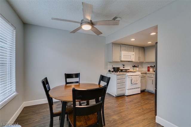 dining space with dark hardwood / wood-style floors, ceiling fan, and a textured ceiling