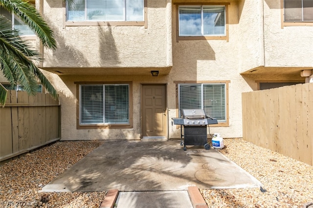 view of exterior entry featuring a patio