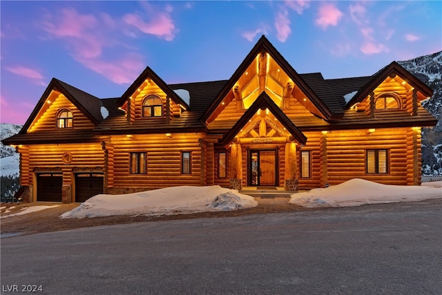 log cabin featuring a porch and a garage