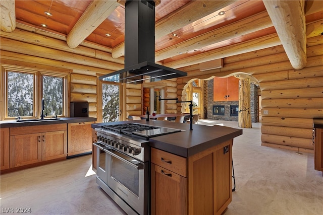 kitchen with sink, log walls, island range hood, and double oven range