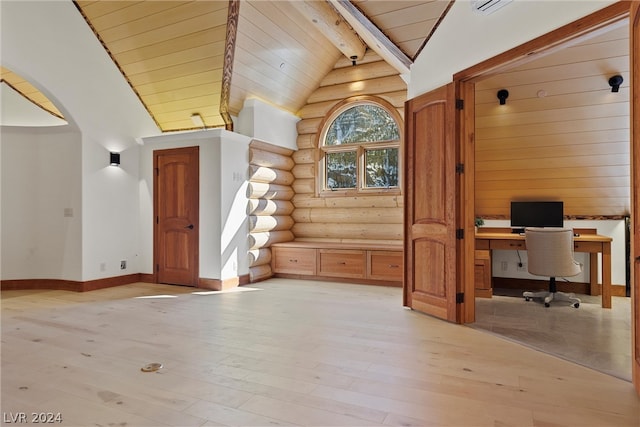 office with lofted ceiling with beams, light hardwood / wood-style floors, log walls, and built in desk