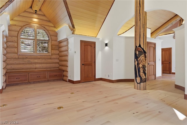 additional living space with high vaulted ceiling, log walls, wood ceiling, beamed ceiling, and light hardwood / wood-style flooring