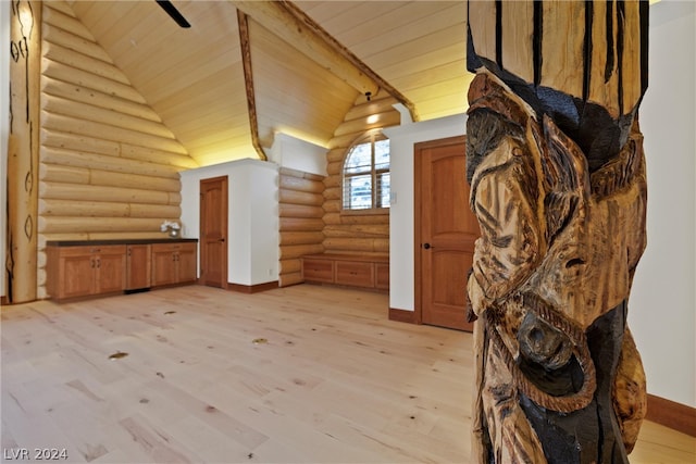 additional living space with lofted ceiling, rustic walls, light hardwood / wood-style floors, and wood ceiling