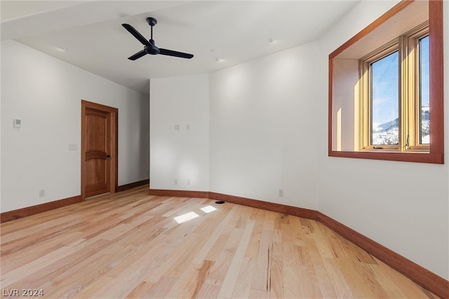 empty room with ceiling fan and light wood-type flooring