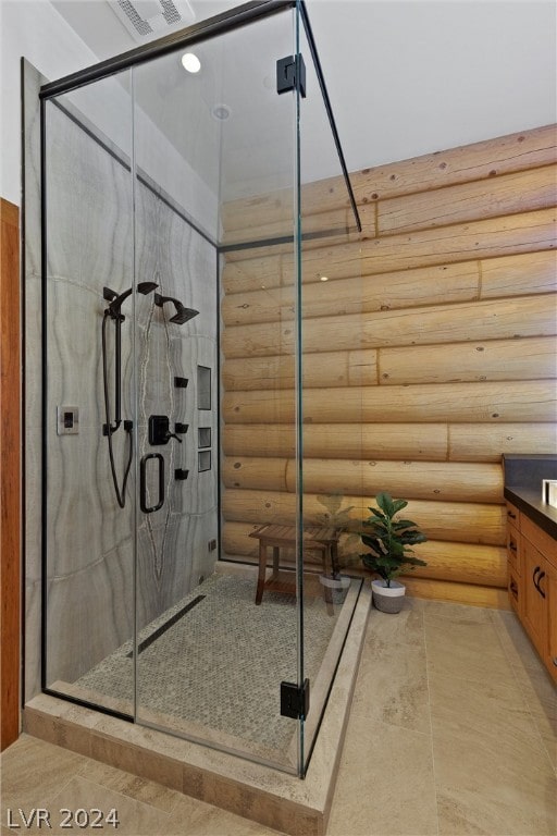 bathroom featuring log walls, a shower with door, and vanity