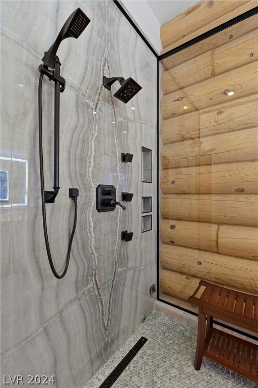 bathroom featuring a shower and rustic walls