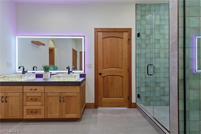 bathroom featuring tile flooring, dual vanity, and walk in shower