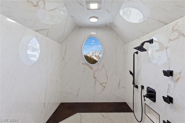 bathroom featuring lofted ceiling