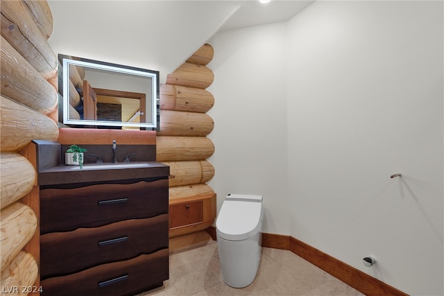 bathroom with log walls, tile floors, toilet, and vanity