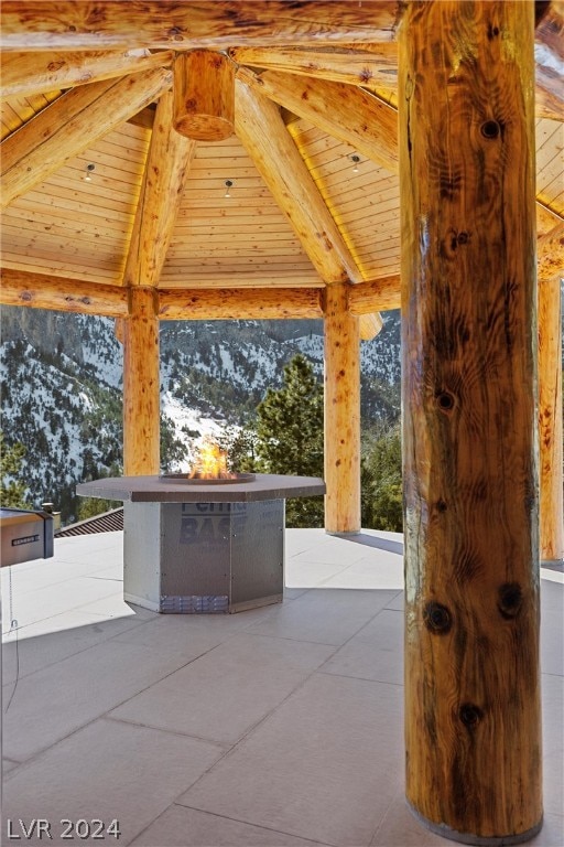 view of patio / terrace featuring a gazebo, a mountain view, and exterior kitchen