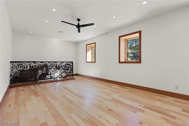 empty room with light hardwood / wood-style floors and ceiling fan