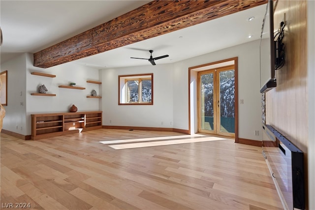 living room with beamed ceiling, ceiling fan, and light wood-type flooring