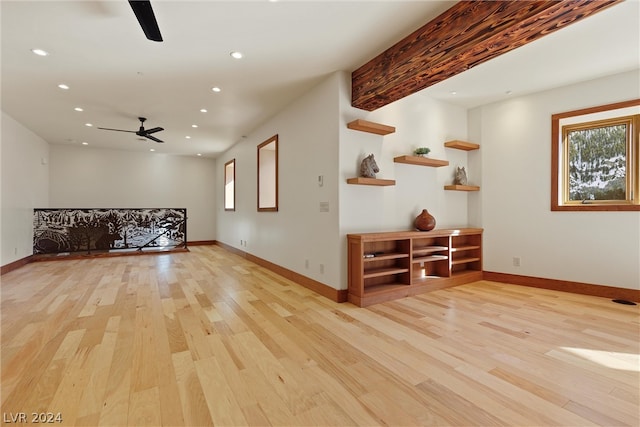 interior space with ceiling fan, light hardwood / wood-style flooring, and beam ceiling