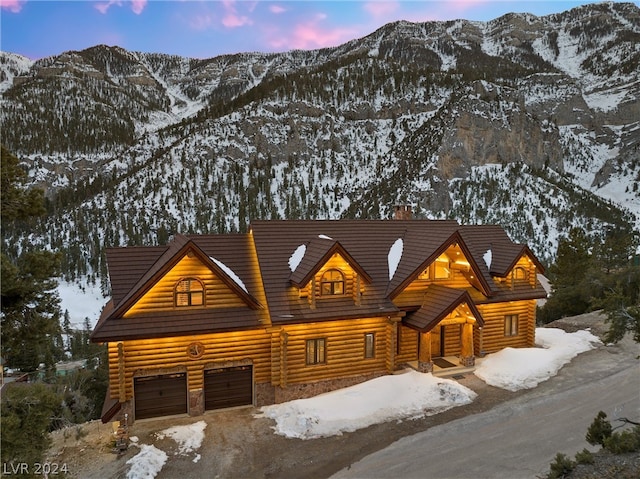 log-style house featuring a mountain view and a garage