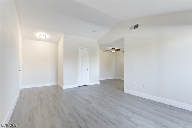 spare room featuring vaulted ceiling, ceiling fan, and light hardwood / wood-style flooring