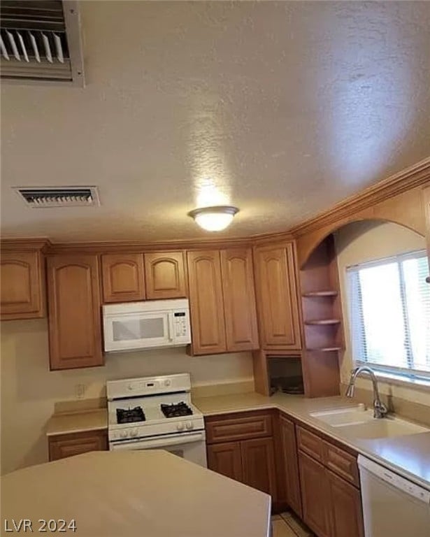 kitchen featuring sink and white appliances