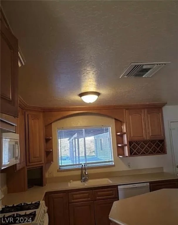 kitchen featuring sink and white appliances