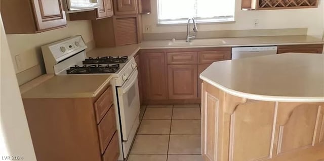 kitchen with sink, white appliances, and light tile floors