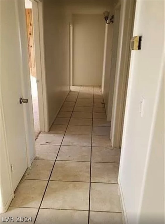 corridor featuring light tile flooring