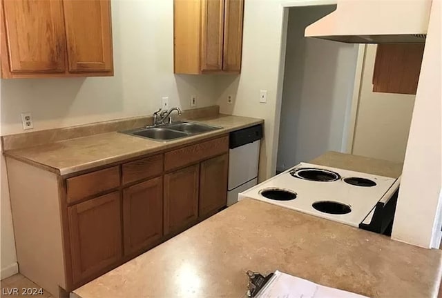 kitchen featuring white dishwasher, stove, custom exhaust hood, and sink