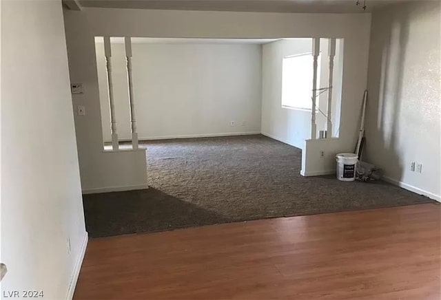 unfurnished room featuring dark wood-type flooring