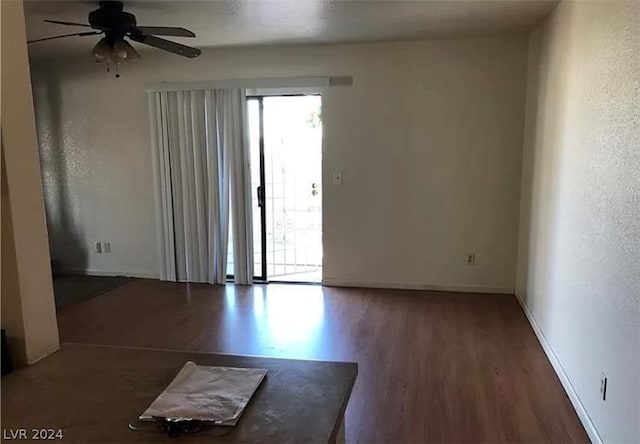 unfurnished room with ceiling fan and dark hardwood / wood-style floors