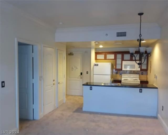 kitchen featuring white appliances, decorative light fixtures, light colored carpet, kitchen peninsula, and a chandelier