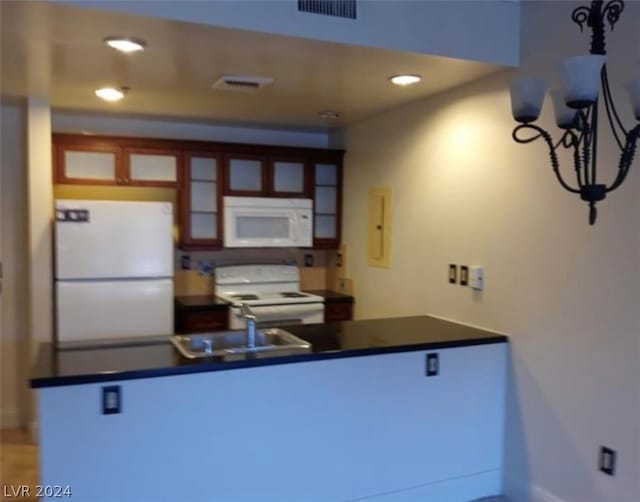 kitchen featuring white appliances and sink