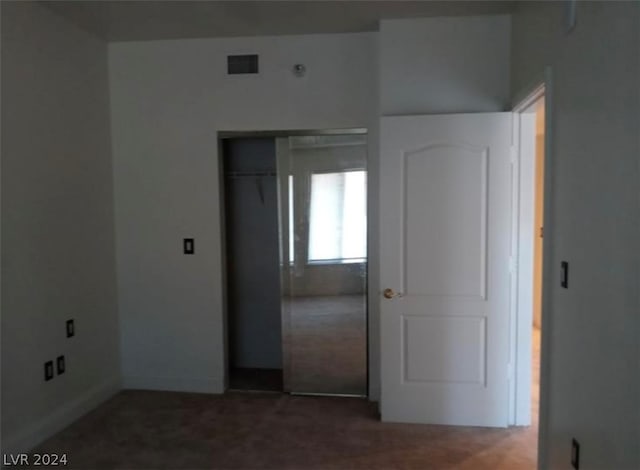 interior space featuring dark colored carpet