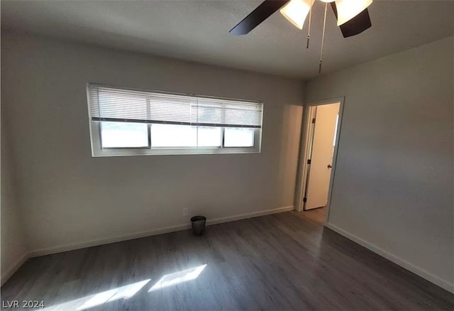 spare room with ceiling fan and dark hardwood / wood-style floors