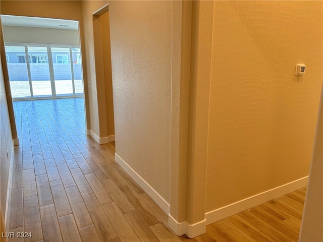 hallway with hardwood / wood-style flooring