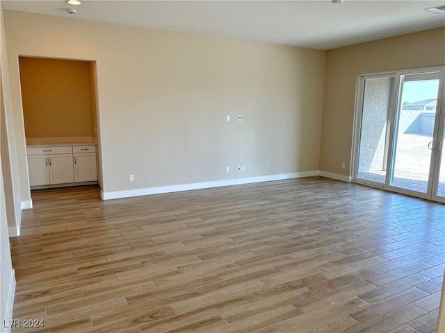 spare room with light wood-type flooring