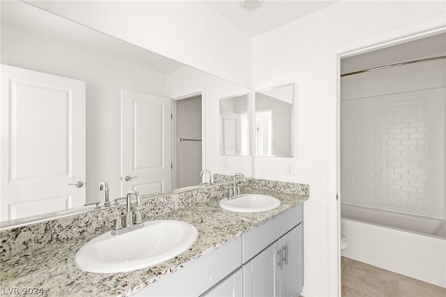 full bathroom featuring dual vanity, tile flooring, shower / bathtub combination, and toilet