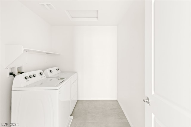 washroom with hookup for a washing machine, independent washer and dryer, and light tile floors