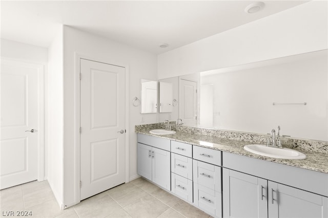 bathroom with tile flooring and dual vanity