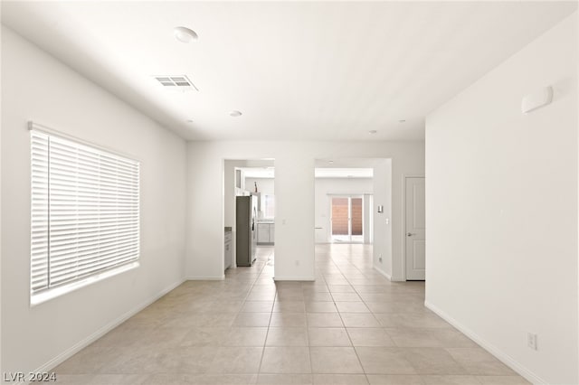 spare room featuring light tile floors