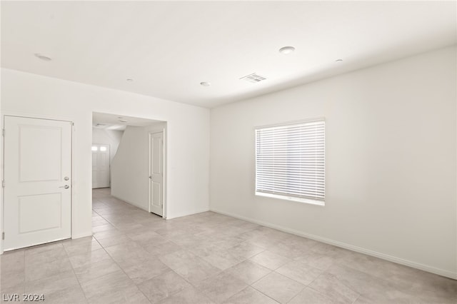 spare room with light tile floors