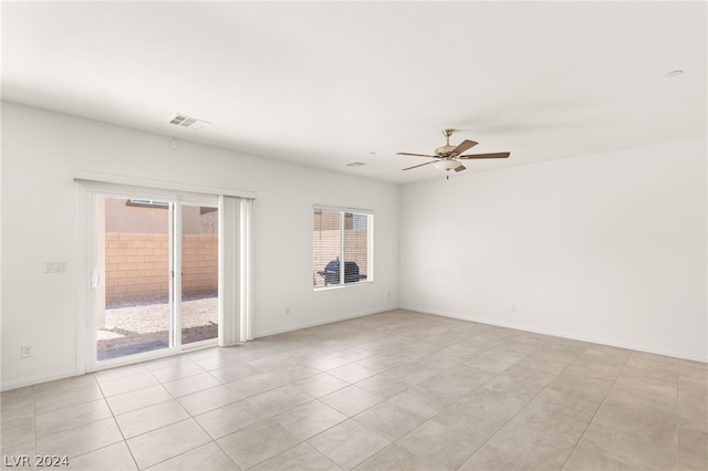 tiled empty room with ceiling fan