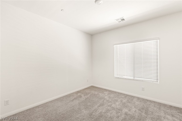 spare room with light colored carpet