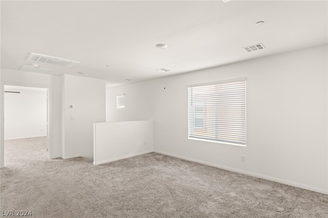 spare room featuring light colored carpet