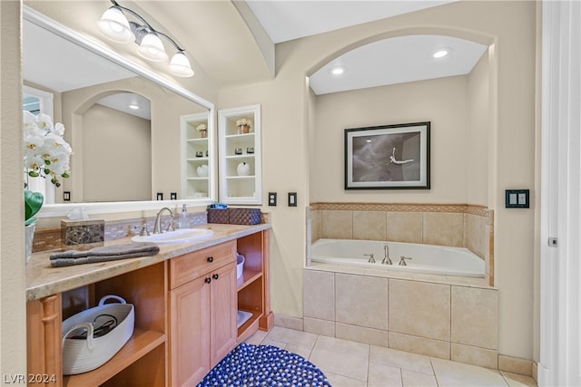 bathroom with tiled bath, tile flooring, and large vanity