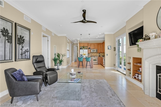 living room with light tile flooring, ceiling fan, and crown molding